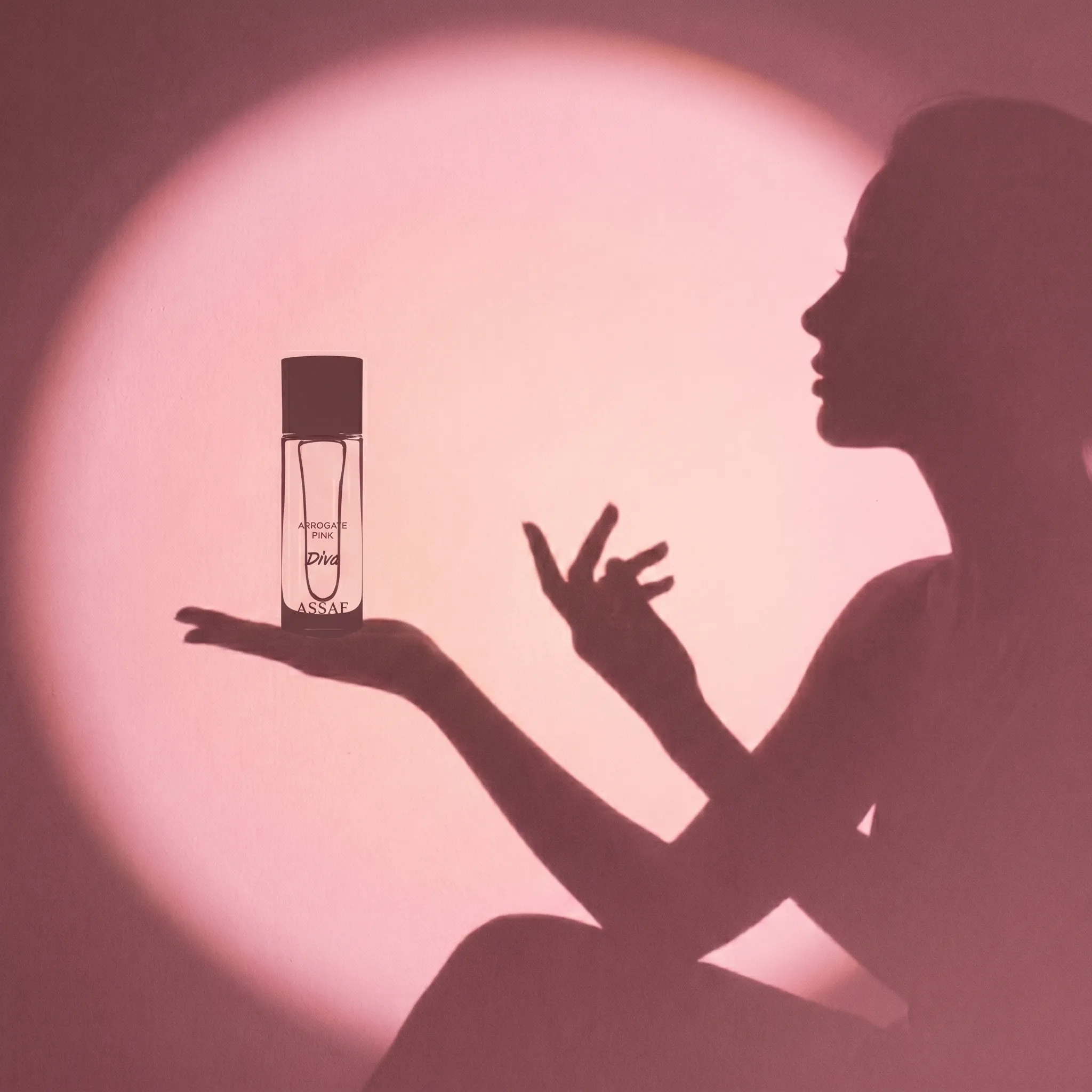 ASSAF teaser — hand holding perfume bottle silhouetted against pink glow